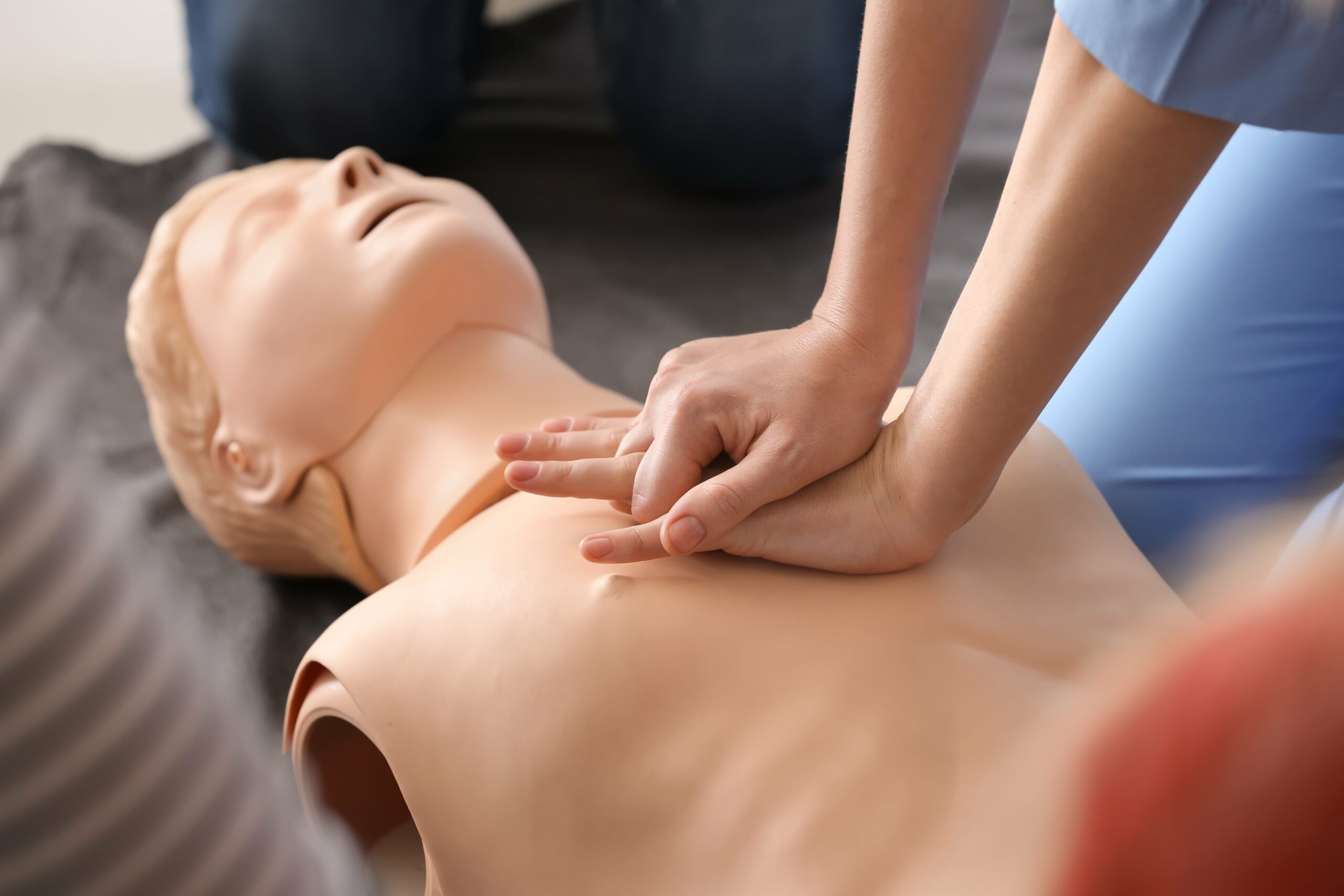 CPR being practiced on a manakin